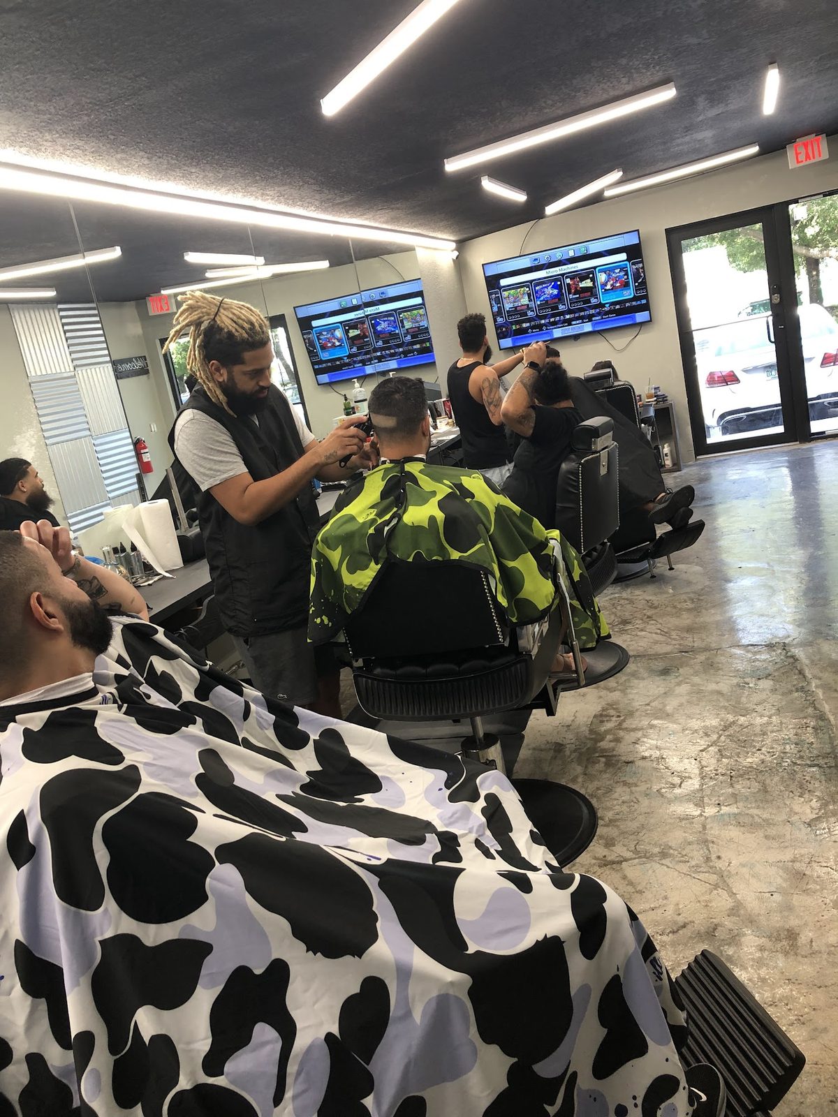 Inside Cuts4Sale Barbershop, with barbers cutting hair in chairs